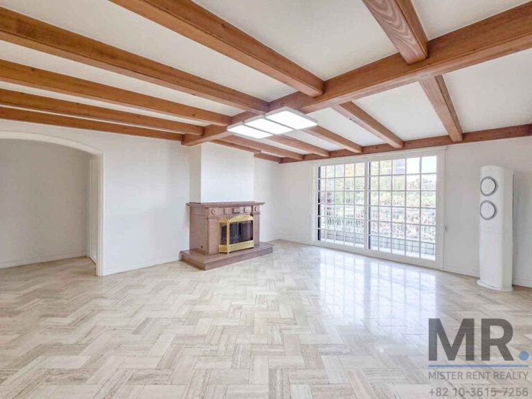 Spacious room with wooden beams.