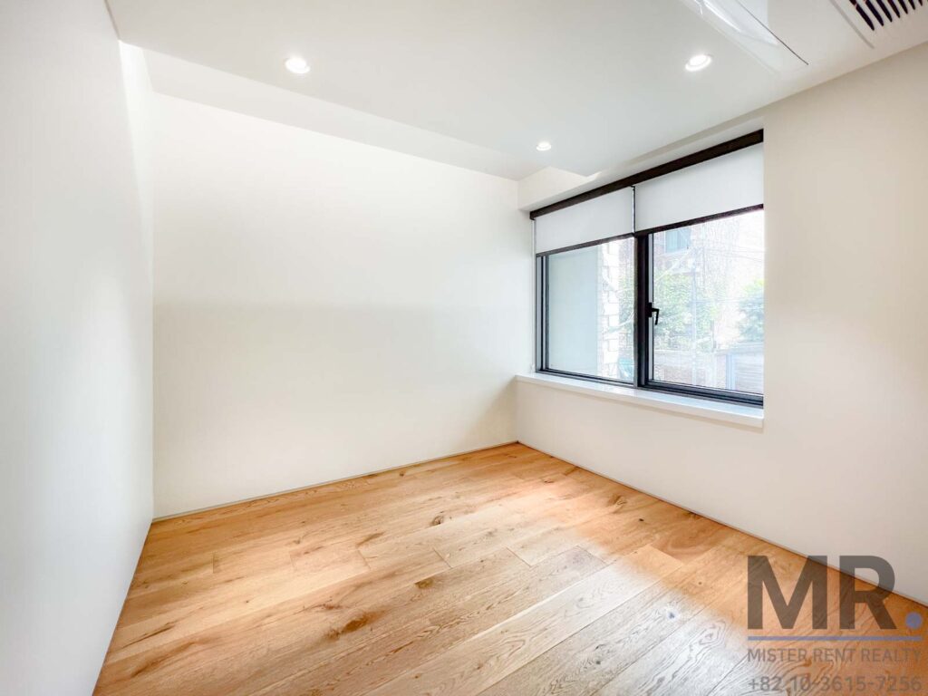 Empty room with wooden flooring.